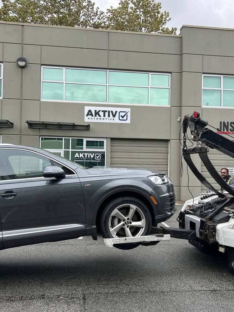 Audi Q7 arriving at Aktiv Automotive on a flatbed tow truck