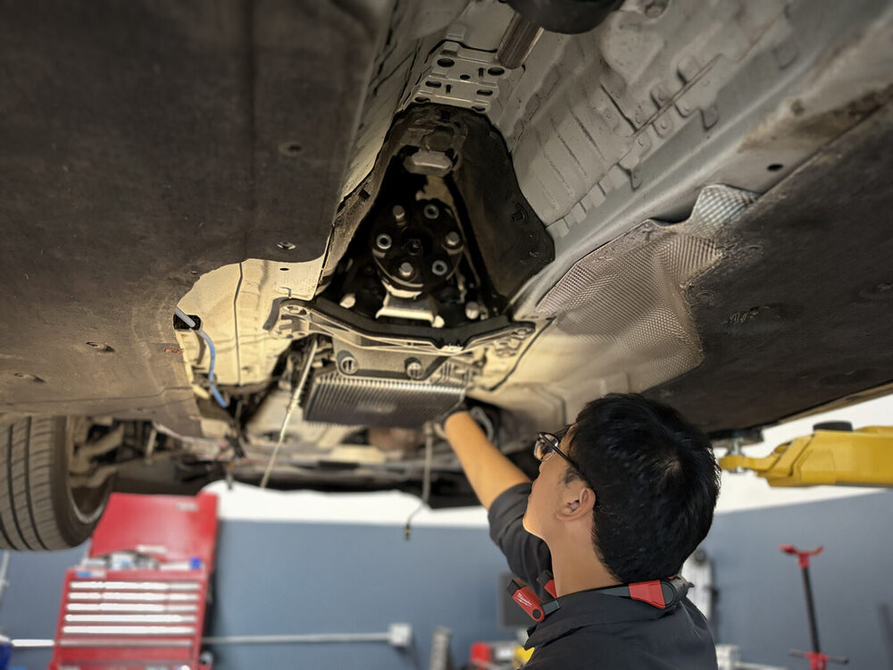 BMW on the lift with hood open for service
