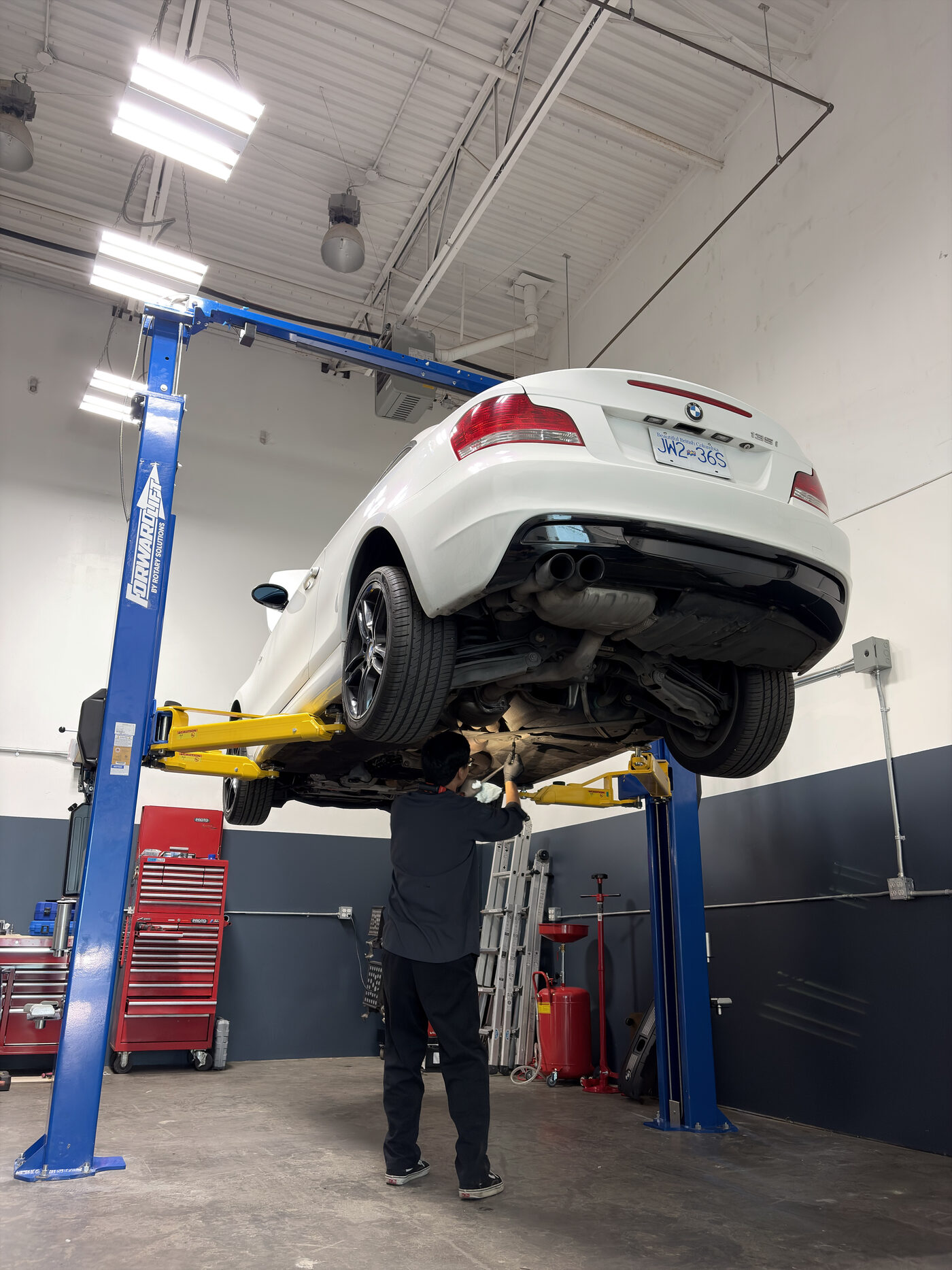 Technician running a factory-level diagnostic scan on a BMW
